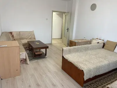 a living room with a bed and a couch at Cosy home in the heart of Bansko in Bansko