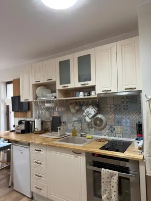 a kitchen with white cabinets and a counter top at Green Line Studio Appartment Pamporovo in Pamporovo