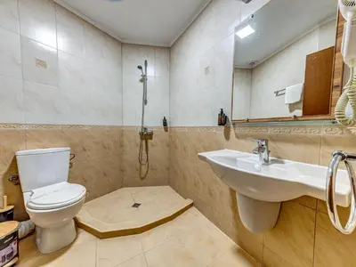 a bathroom with a toilet and a sink at Хотел Елит Релакс in Devin