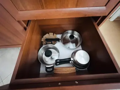a miniature kitchen with two pots and pans in a drawer at Bansko 3 Ski To Door Apartment in Bansko
