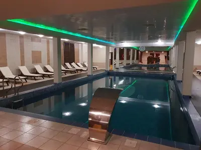 a pool with a pool table in a building at Superior studio with terrace in 4star Green Life Bansko in Bansko