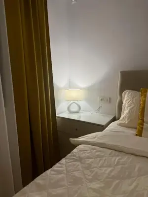 a bedroom with a bed and a lamp on a table at Apartment Juliet in Sofia