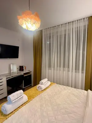a bedroom with a bed with two towels on it at Apartment Juliet in Sofia