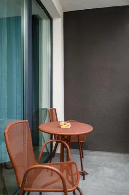 a red table and chairs in a room at Modern Stay with Balcony in Sofia