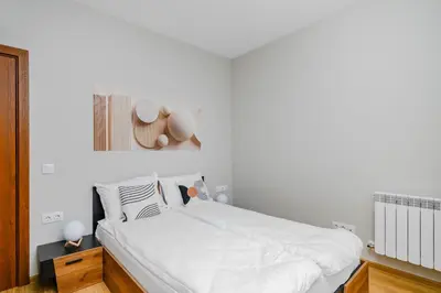 a bedroom with a bed with a hat on the wall at Modern Stay with Balcony in Sofia