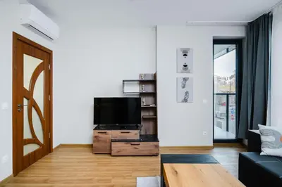a living room with a tv and a couch at Modern Stay with Balcony in Sofia
