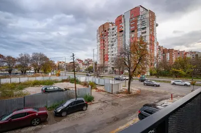 a parking lot with cars parked in front of a building at Modern Stay with Balcony in Sofia