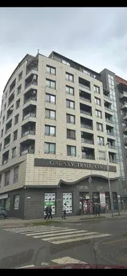a large building with people walking in front of it at GALAXY apartment in Sofia