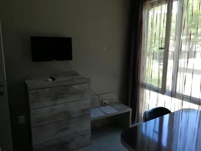 a living room with a tv on top of a dresser at Studio 11 Plovdiv in Plovdiv
