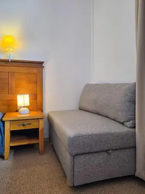 a room with a couch and a table with a lamp at EDEL View! 1BR Ap with Top Mountain View in Bansko in Bansko