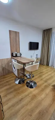 a room with a table and two chairs and a television at Lux Apartment B11 in Bansko