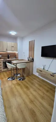 a kitchen with a table and chairs in a room at Lux Apartment B11 in Bansko