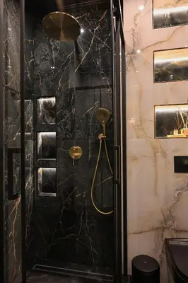 a bathroom with a shower with black marble at All Seasons Apartment 2 in Sofia