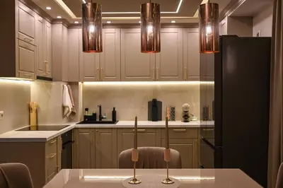 a kitchen with a black refrigerator and some lights at All Seasons Apartment 2 in Sofia