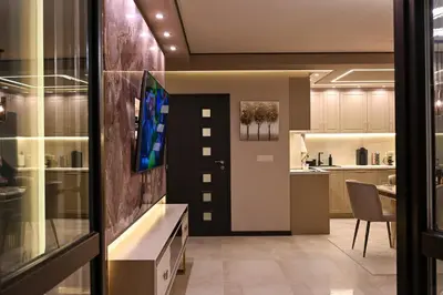 a living room with a tv and a kitchen at All Seasons Apartment 2 in Sofia