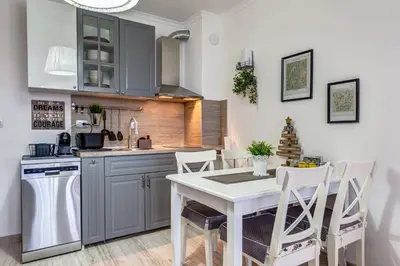 a kitchen with a table and chairs in a room at Sweet Home Family Lodge at Grand Monastery in Smolyan