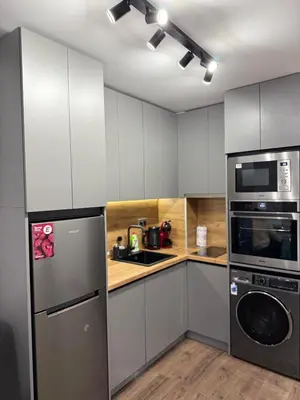 a kitchen with white cabinets and a washer and dryer at Dream Apart - Iceberg in Pamporovo