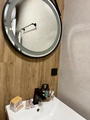 a bathroom sink with a large mirror on the wall at Dream Apart - Iceberg in Pamporovo