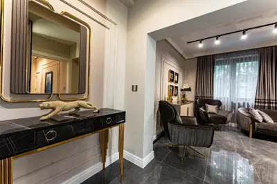 a room with a mirror and a desk with a lion statue at Exclusive Luxury Central Apartment in Sofia