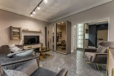 a living room with two couches and a television at Exclusive Luxury Central Apartment in Sofia