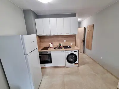 a kitchen with a white refrigerator and a washing machine at Flex loft in Sofia