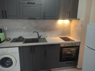 a kitchen with a sink and a stove at Апартамент за гости НИКОЛОВА in Plovdiv