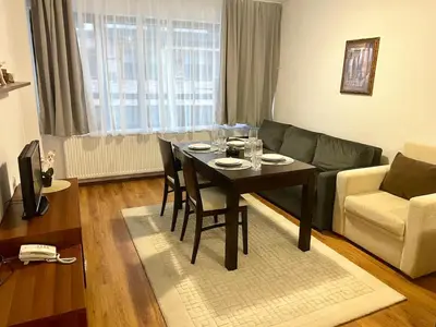a living room with a table and a couch at The Cozy Spot by the Ski Lift Gondola by SI Stay in Bansko