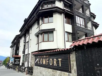 a large white building with a sign in front of it at The Cozy Spot by the Ski Lift Gondola by SI Stay in Bansko