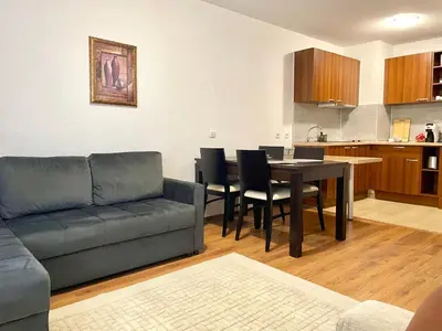 a living room with a couch and a table at The Cozy Spot by the Ski Lift Gondola by SI Stay in Bansko