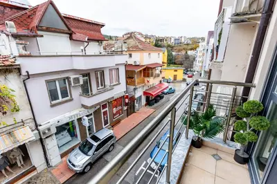 an apartment balcony with a car parked on a street at City Home Sandanski in Sandanski