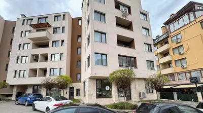 an apartment building with cars parked in front of it at Harmony Apartment by 7th Sence in Sofia