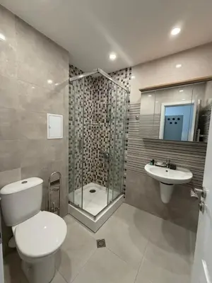a bathroom with a toilet and a shower and a sink at Harmony Apartment by 7th Sence in Sofia
