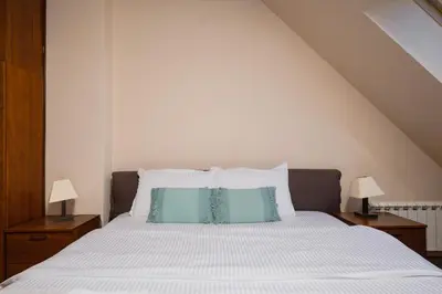 a bedroom with a bed with blue pillows at Flower garden in Lozenetz by 7th Sence in Sofia
