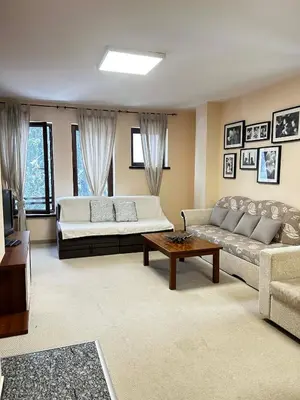 a living room with a couch and a table at Green Point Apartment A18 in Pamporovo