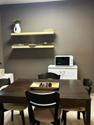 a dining room with a wooden table and chairs at Green Point Apartment A18 in Pamporovo