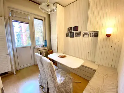 a room with a table and chairs and a window at Comedy Theatre apartments in Sofia