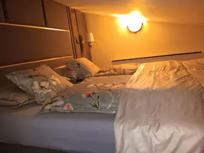 a bed with white sheets and flowers on it at Аppartment Dreams in Pamporovo