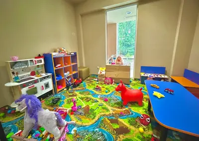 a childs room with a table and toys on the floor at Apartment Alex in Borovets