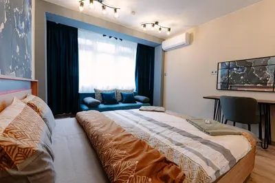 a bedroom with a large bed and a window at 1 minute to main Street Grafa, NDK, FREE Parking, 3BDR in Sofia