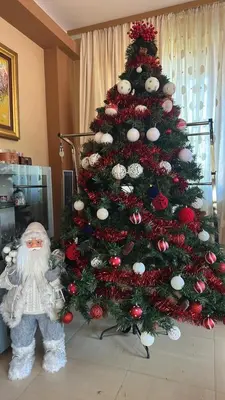 a christmas tree with a santa clause next to it at Ava Apartment Pamporovo in Pamporovo