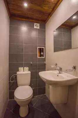 a bathroom with a toilet and a sink at Stylish Two-Level Apartment in Bansko by Flat Mаnаger in Blagoevgrad