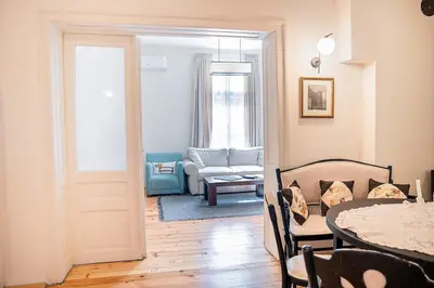 a living room with a table and a couch at Big Apartment in Center Sofia - 2 BD - Fireplace in Sofia