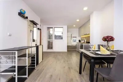 a kitchen and living room with a table and chairs at Top-Floor Flat with Balcony by Flat Manаger in Plovdiv