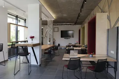 a room with tables and chairs and a tv at Apartment with an amazing view - near Bansko in Razlog