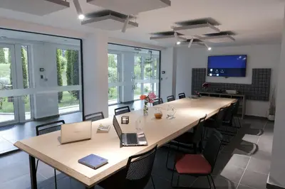 a conference room with a large table with chairs and a laptop at Apartment with an amazing view - near Bansko in Razlog