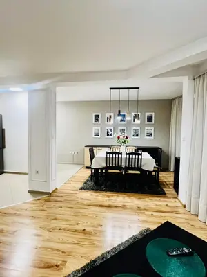 a dining room with a table in a room at Urban Glow Apartment near Metro Station in Sofia