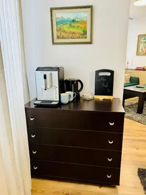 a dresser with a coffee maker on top of it at Urban Glow Apartment near Metro Station in Sofia