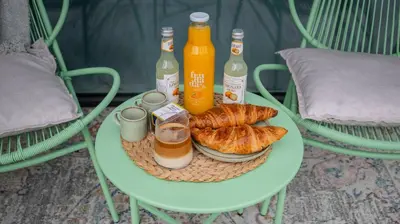 a table with drinks and croissants and bottles of beer at Unique Designer Retreat | Mins to Gondola - Patio! in Bansko