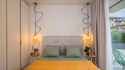 a bed with two pillows in a room with a window at Unique Designer Retreat | Mins to Gondola - Patio! in Bansko