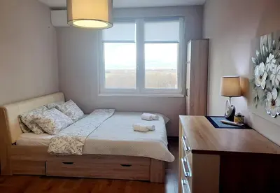 a bedroom with a bed with a window and a desk at LevskiG Family Flat 10 min from Sofia Airport and city center in Sofia